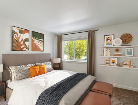 a bedroom with a large bed and a window