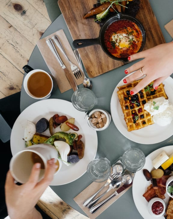 a table filled with plates of food and drinks