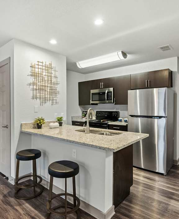 A kitchen with a bar stool and a counter.