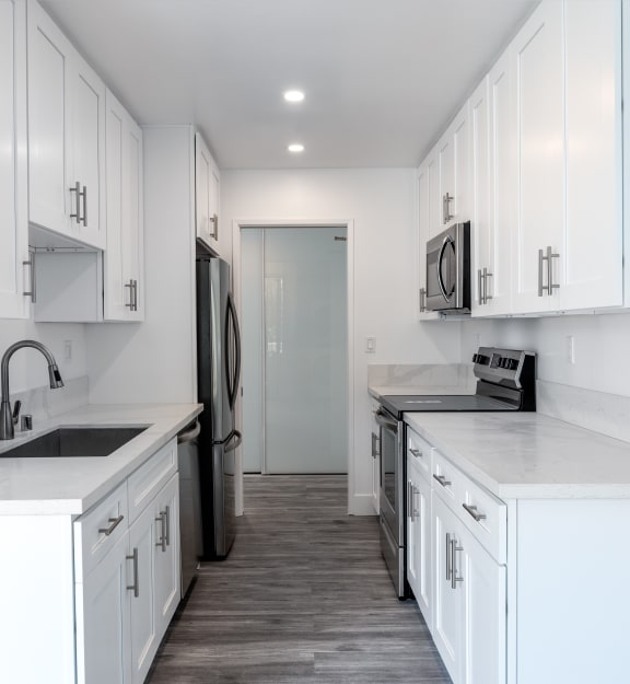 a kitchen with a sink stove and microwave