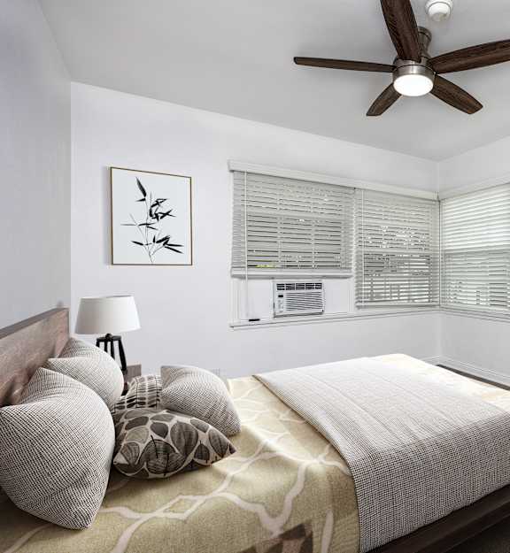 a bedroom with a large bed and a ceiling fan