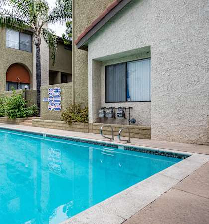a swimming pool with a building in the background