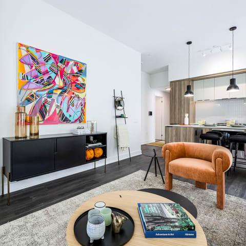 a living room with a couch and a table and a kitchen