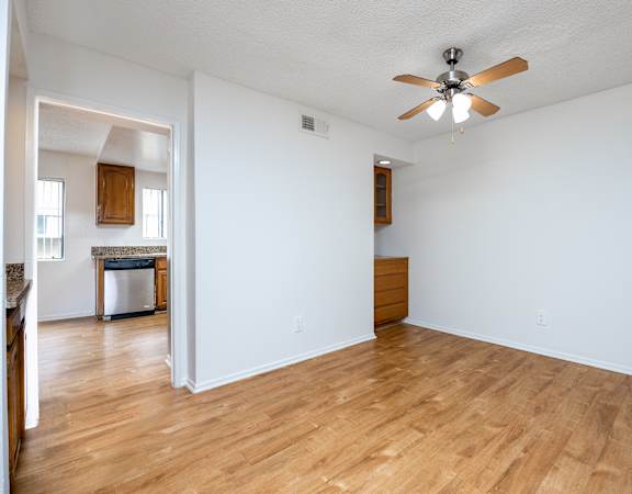 a living room with hardwood floors and a ceiling fan
