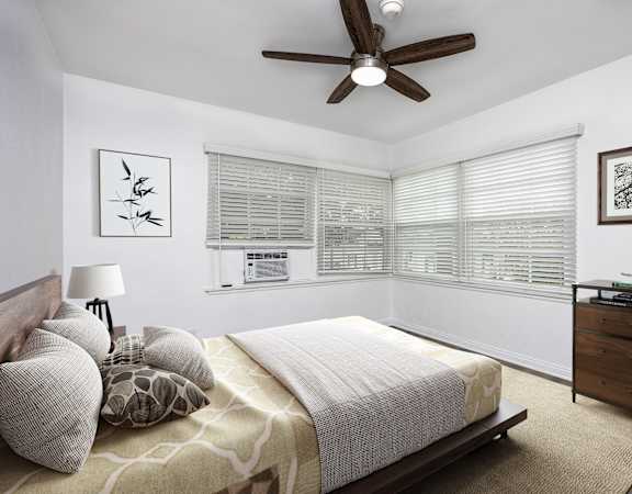 a bedroom with a large bed and a ceiling fan