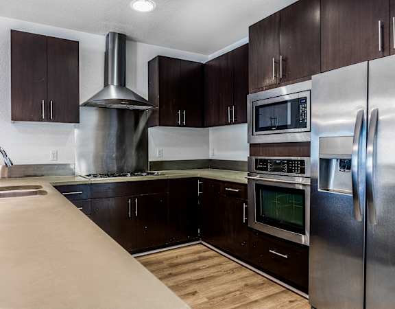 a kitchen with stainless steel appliances and wooden cabinets