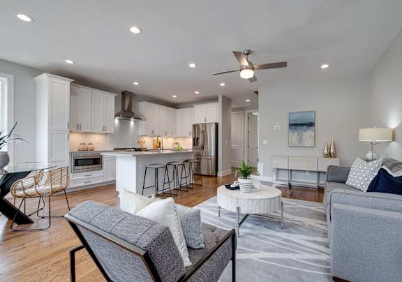 A modern kitchen with a white countertop and stainless steel appliances.