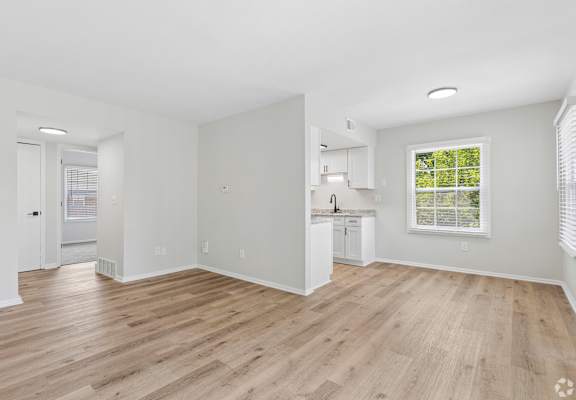 A room with wooden floors and white walls.