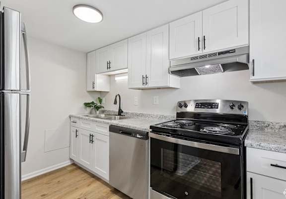A kitchen with a stove, oven, and refrigerator.