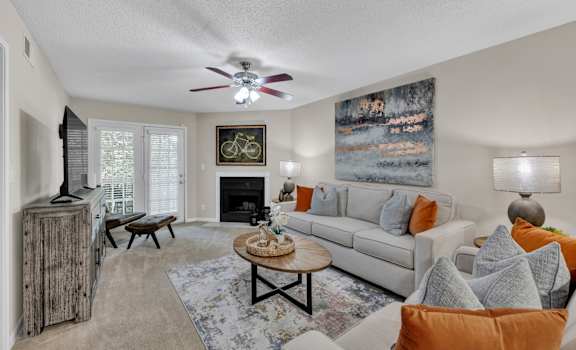a living room with a couch and a ceiling fan