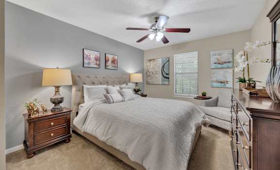 a bedroom with a bed and a ceiling fan