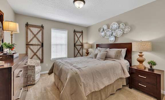 a bedroom with a bed and a dresser and a window