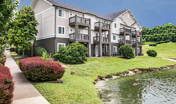 an apartment building with a river in front of it