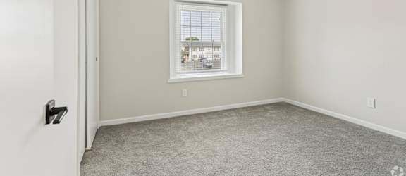 A room with a window and a door.