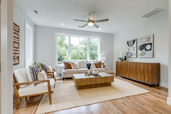A modern living room with a fireplace and a large sectional sofa.