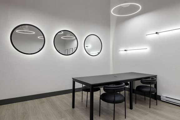 A modern dining room with a table and chairs.