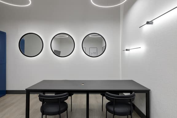 A conference room with a long table and two chairs.