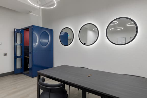 A blue cabinet with a mirror on top of it.