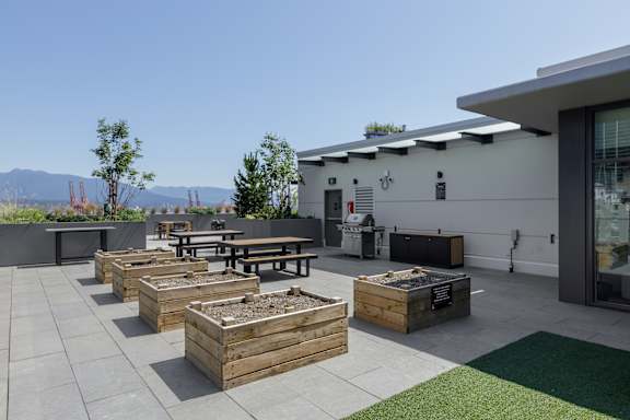 A patio with a table and chairs and a building in the background.