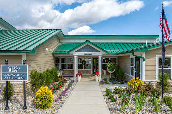 The front of a building with a sign that says "American Leasing Office & Clubhouse".