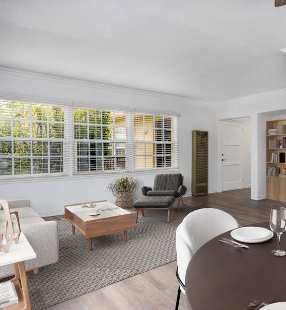 a living room with hardwood floors and white walls