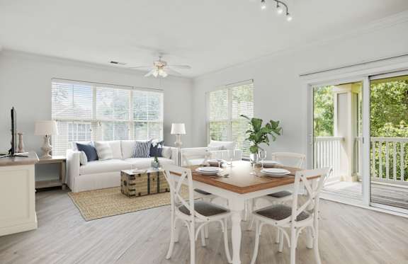 A dining room with a white table and chairs.