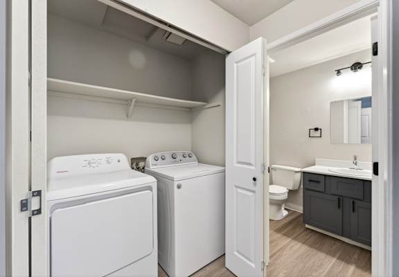 A small laundry room with a washer and dryer.