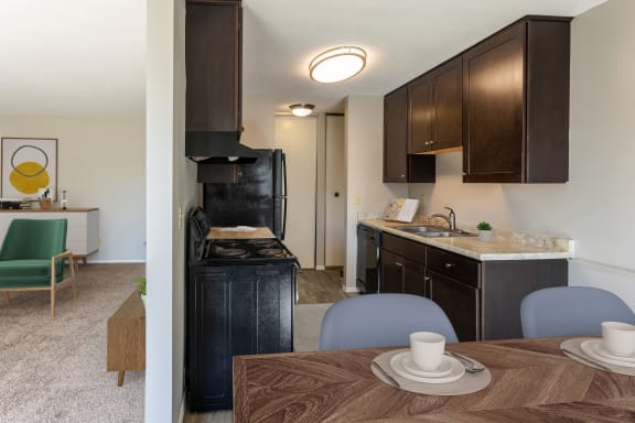 the view of a kitchen and dining room with a table and chairs