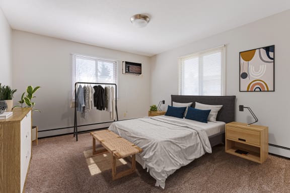 a bedroom with a bed and a dresser and two windows