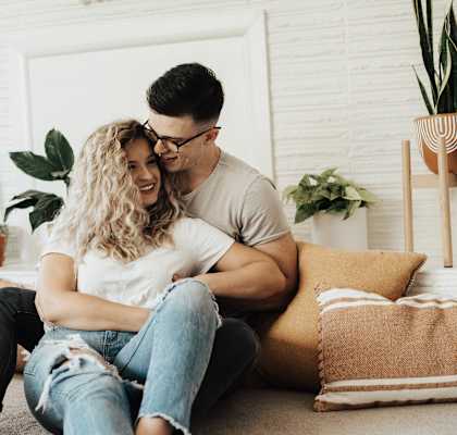 a couple sitting on a couch in their living room