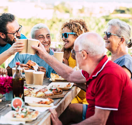 a group of people sitting around a table eating food