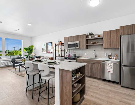 A modern kitchen with a dining table and chairs.