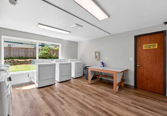 A room with a wooden floor and a brown door.