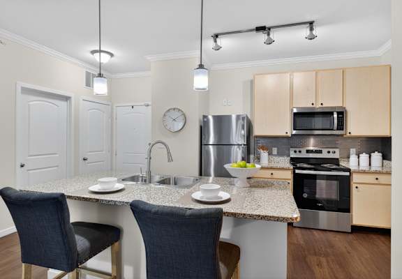 A kitchen with a table and chairs.