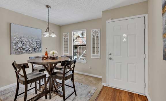 a dining room with a table and chairs and a white door