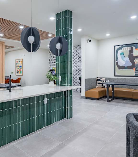 A modern kitchen with green tiled backsplash and a grey countertop at The Collective Upper Westside Apartments, Atlanta, GA, 30318