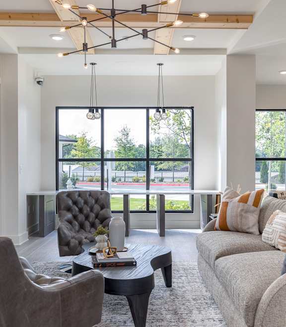 A modern living room with a grey sofa, a black chair, and a coffee table.A modern living room with a grey sofa, a black chair, and a coffee table at The Collective Upper Westside Apartments, Atlanta,