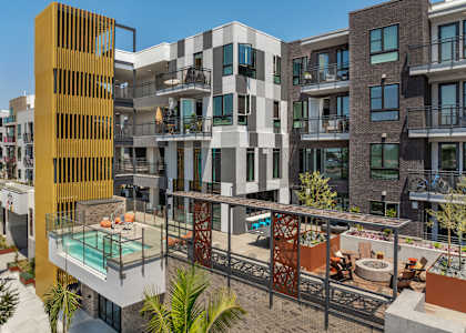 Modern apartment complex with a pool and balconies at AMP 30 Apartments, San Diego, CA