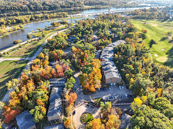 A beautiful aerial view of a golf course surrounded by trees in autumn.