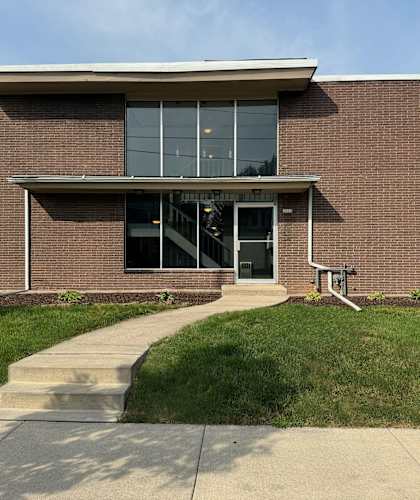 a brick building with a sidewalk in front of it