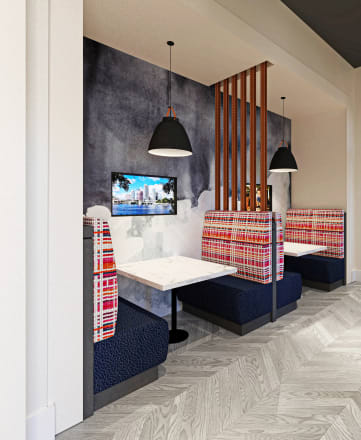 a rendering of a restaurant with blue booths and a black wall with a tv on the wall