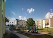 Thumbnail 2 of 5 - an image of a playground in front of an apartment building