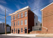 Thumbnail 3 of 4 - a brick building on the corner of a street