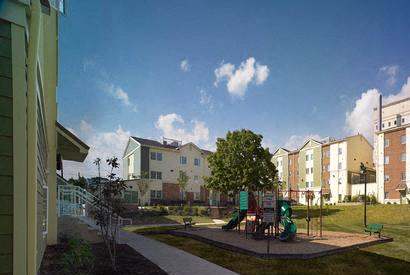 an image of a playground in front of an apartment building