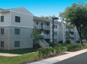 an apartment building with a street light in front of it