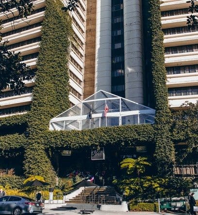 a large building with a green wall on the side of it