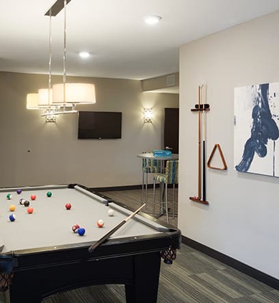 a game room with a pool table and a tv at Gabella at Parkside, Minnesota, 55124