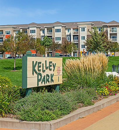 a sign with an apartment building in the background at Gabella at Parkside, Minnesota, 55124