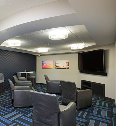 a living room with chairs and a tv at Gabella at Parkside, Minnesota