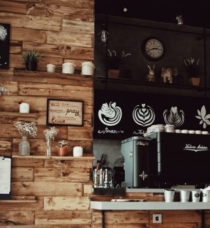 a coffee shop with a wooden wall and a coffee machine
